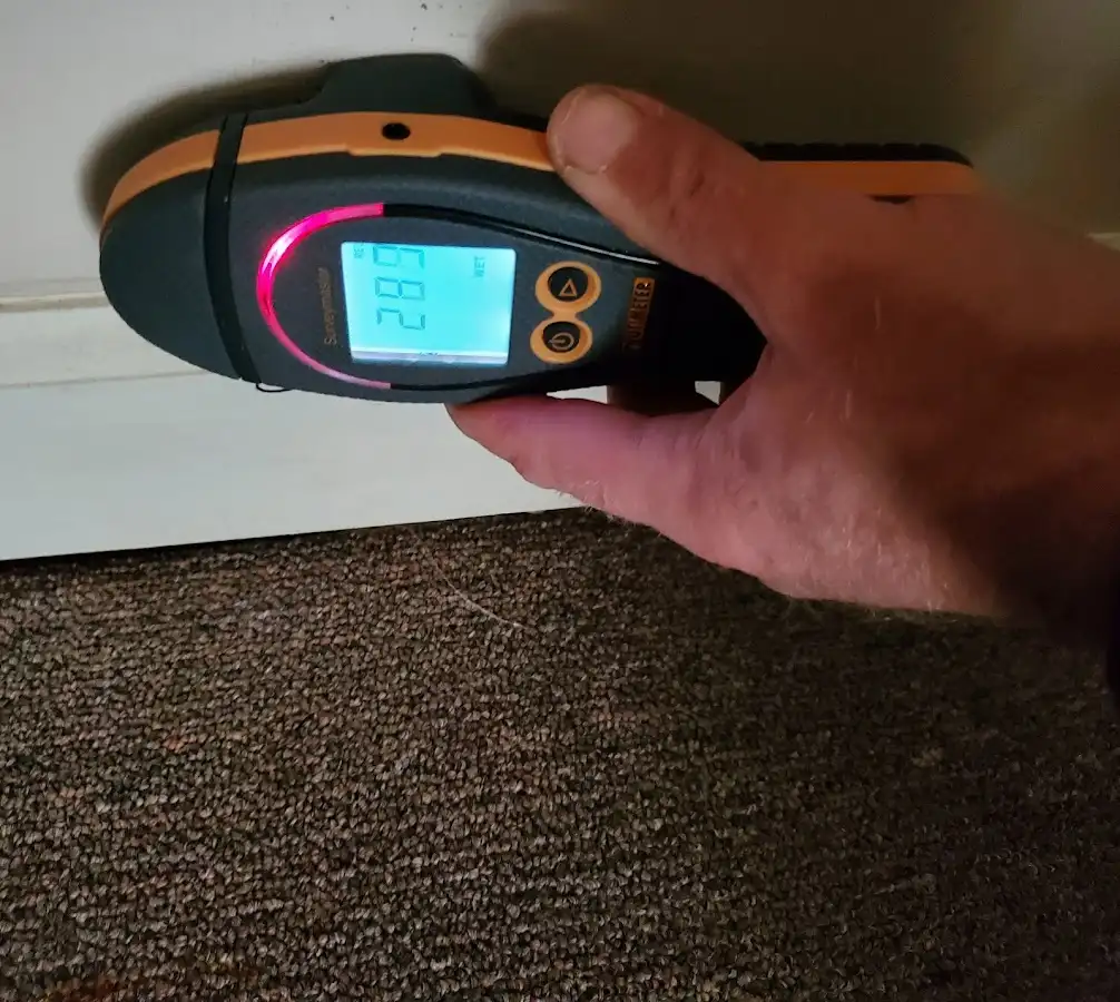 Moisture detection at baseboard during Storm Damage Restoration in Windsor Heights